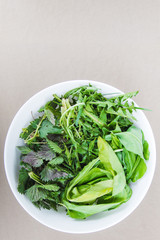 Top view of a fresh healthy greens in a white bowl