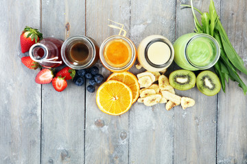 Selection of colorful smoothies on rustic background
