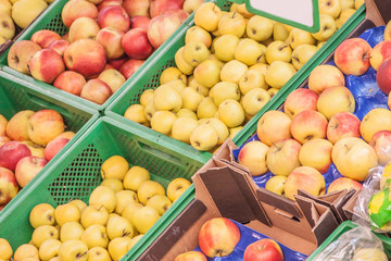 Bunch of apples fruits on boxes in supermarket