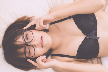 sexy young woman model in sexy black lingerie posing on the bed