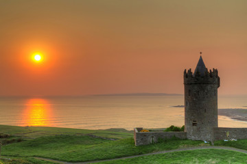 Fototapeta na wymiar Doonegore castle at sunset in Doolin, Ireland