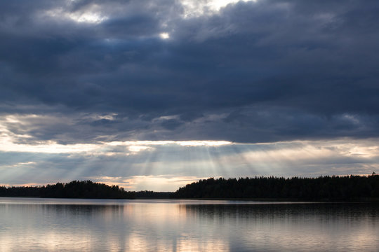 Beams of light over the lake and forest