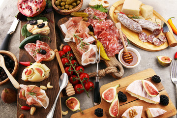 Italian antipasti wine snacks set. Cheese variety, Mediterranean olives, pickles, Prosciutto di Parma and salami