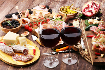 Italian antipasti wine snacks set. Cheese variety, Mediterranean olives, pickles, Prosciutto di Parma and salami