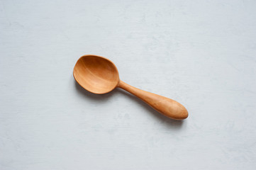 Wooden spoon handmade close-up on a gray background.