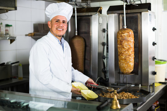 man chef serving fresh kebab