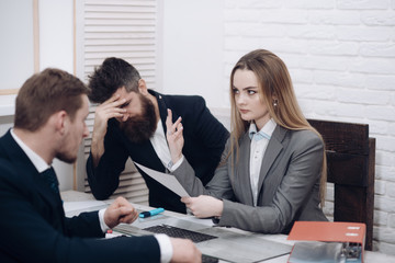 Woman accountant explain economic indicators. Business partners, disappointed businessmen at meeting, office background. Business negotiations, economist calculates losses. Business losses concept.