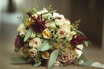 Obraz na płótnie Canvas lush bridal bouquet with burgundy flowers