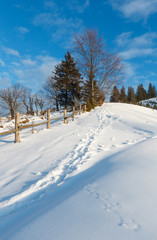 Fototapeta na wymiar Winter morning mountain rural snow covered path