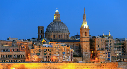 Fototapeta na wymiar Valletta, Malta, Skyline in the evening with the dome of the Carmelite Church and the tower of St Paul`s