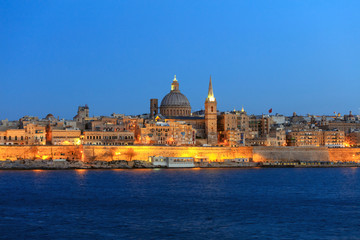 Fototapeta na wymiar Valletta, Malta, Skyline in the evening with the dome of the Carmelite Church and the tower of St Paul`s