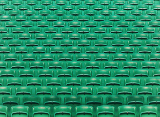 Green empty stadium folding seats background