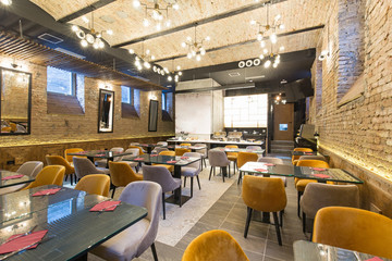 Interior of a modern hotel restaurant with brick wall