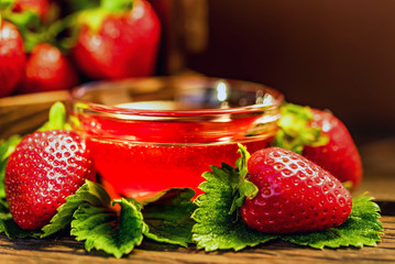 Fresh strawberries with leaves and jam close