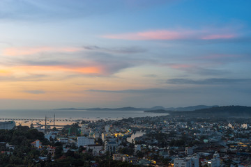 Beautiful aerial view from the high on Duong Dong town, sea, bay and hills at colorful sunset. Phu Quoc Island, Vietnam.