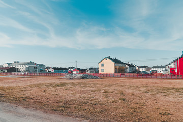 Fototapeta premium Norway Vardo, houses in a neighborhood on a summer day with some snow still left