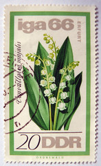 Leeds, England - April 18 2018: An old east german stamp with a lily of the valley design