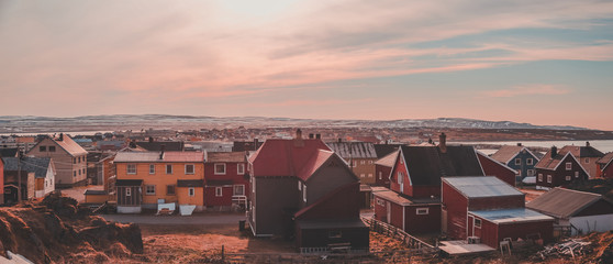 View of Vardo city with houses and mountains in the back on the mainland, Norway