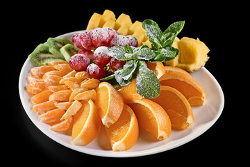 various types of citrus fruit on a dark background