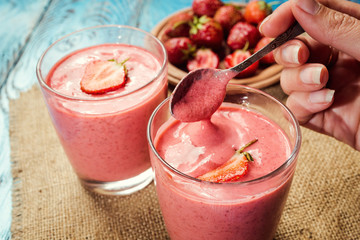 healthy strawberry yogurt with fresh berries on old wooden background