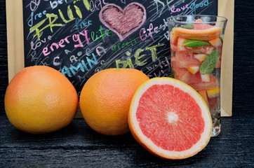 glass water with grapefruit on table