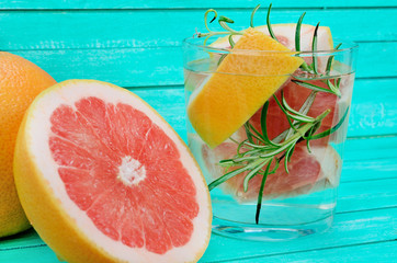 glass water with grapefruit on table
