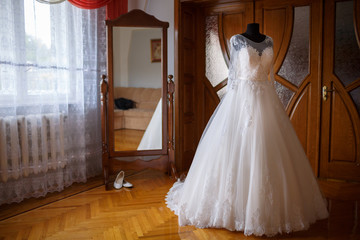 elegant wedding dress by the mirror