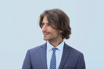 Handsome man in stylish clothes is looking away and smiling