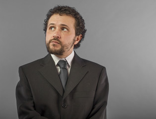 Portrait of confidence and success. Portrait of handsome mature man in shirt and tie keeping arms crossed and looking at camera while standing against grey background