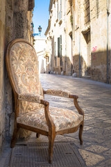 Plakat Old chair in a traditional street of Lecce, Italy.