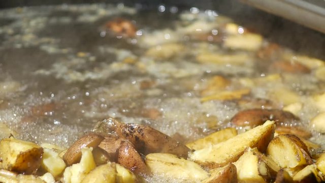 American potatoes with salt pepper and cumin in roasted pan.