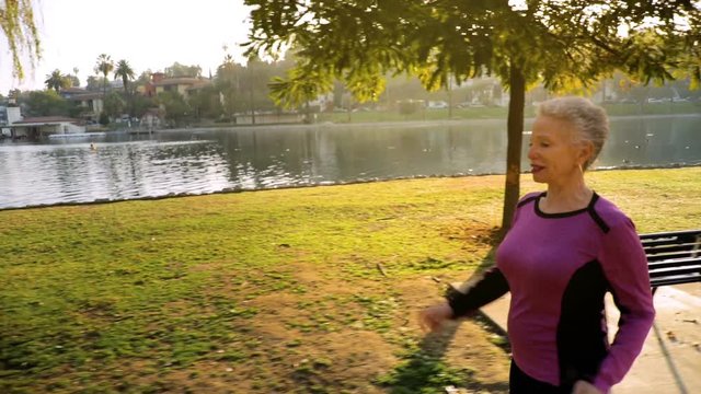 71 year old woman going for her morning walk in the park.