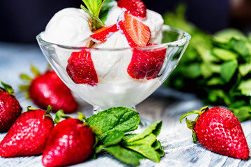 Strawberry ice cream in bowl and strawberries