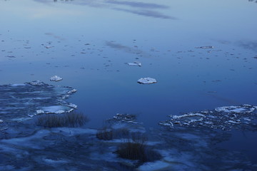ice drift on the river. large ice floes floating on the water. spring is melting ice cracking. top view of the river