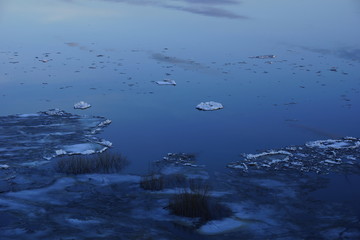 ice drift on the river. large ice floes floating on the water. spring is melting ice cracking. top view of the river
