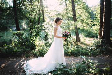 Beautiful bride. Wedding day. Very beautiful bride in a luxurious wedding dress, looks at her...