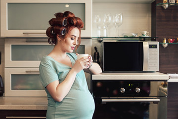 Fototapeta na wymiar Portrait pregnant woman drinking tea