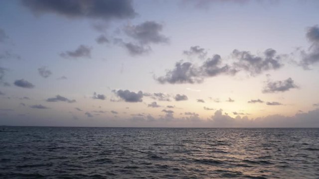 Rising sun on the horizon above a calm ocean