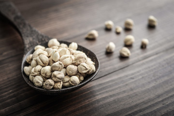 Cardamom in wooden spoon