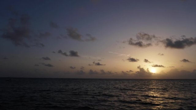Rising sun on the horizon above a calm ocean