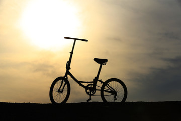 Fototapeta na wymiar A parked bike in the setting sun