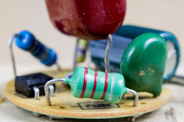 Electronics in high magnification. Resistors and diodes are soldered to an electronic board.