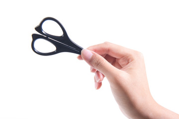 Female hand holding scissors on white background
