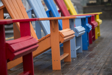 A row of colored muskoka chairs