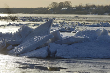 large pieces of ice are white.ice drift on the river. large ice floes floating on the water. spring is melting ice cracking.