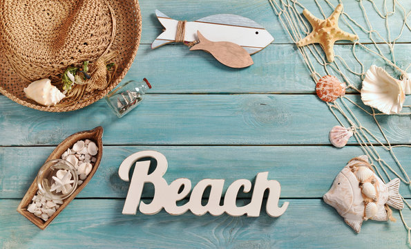 summer bacground with beach accessories on blue wooden board