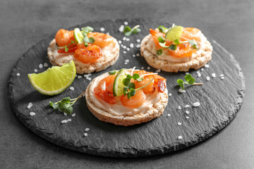 Delicious small sandwiches with shrimps on slate plate