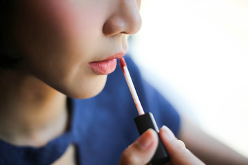 Beautiful woman, dyes her lips lipstick pink,red,orange,. Cosmetics, beauty concept.