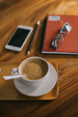 Cup of art latte or cappuccino coffee with retro filter effect