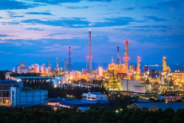 Fototapeta premium Petroleum refinery industry plant with lighting on twilight time